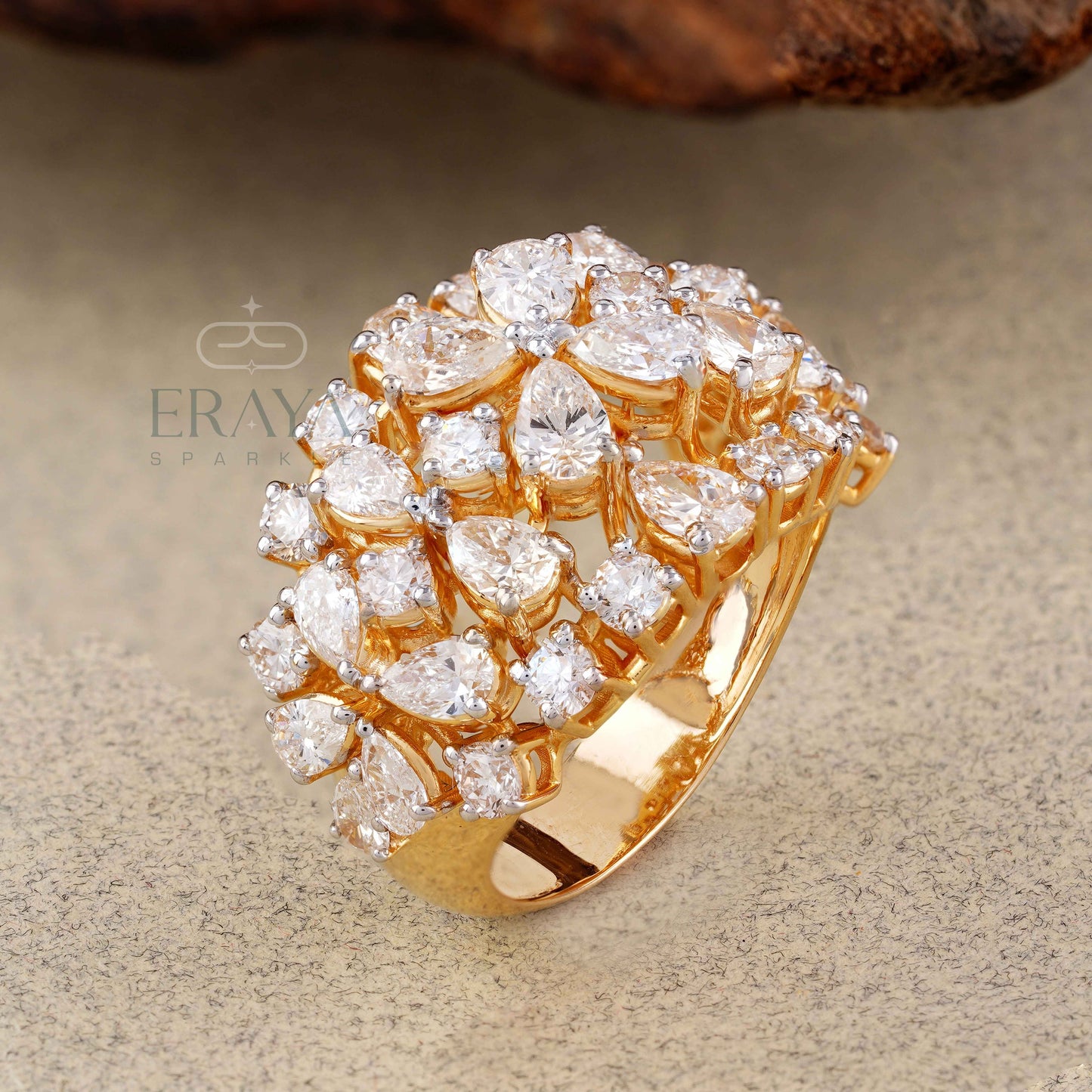 Gold ring with diamond accents on a textured surface, featuring the brand 'Eraya'.