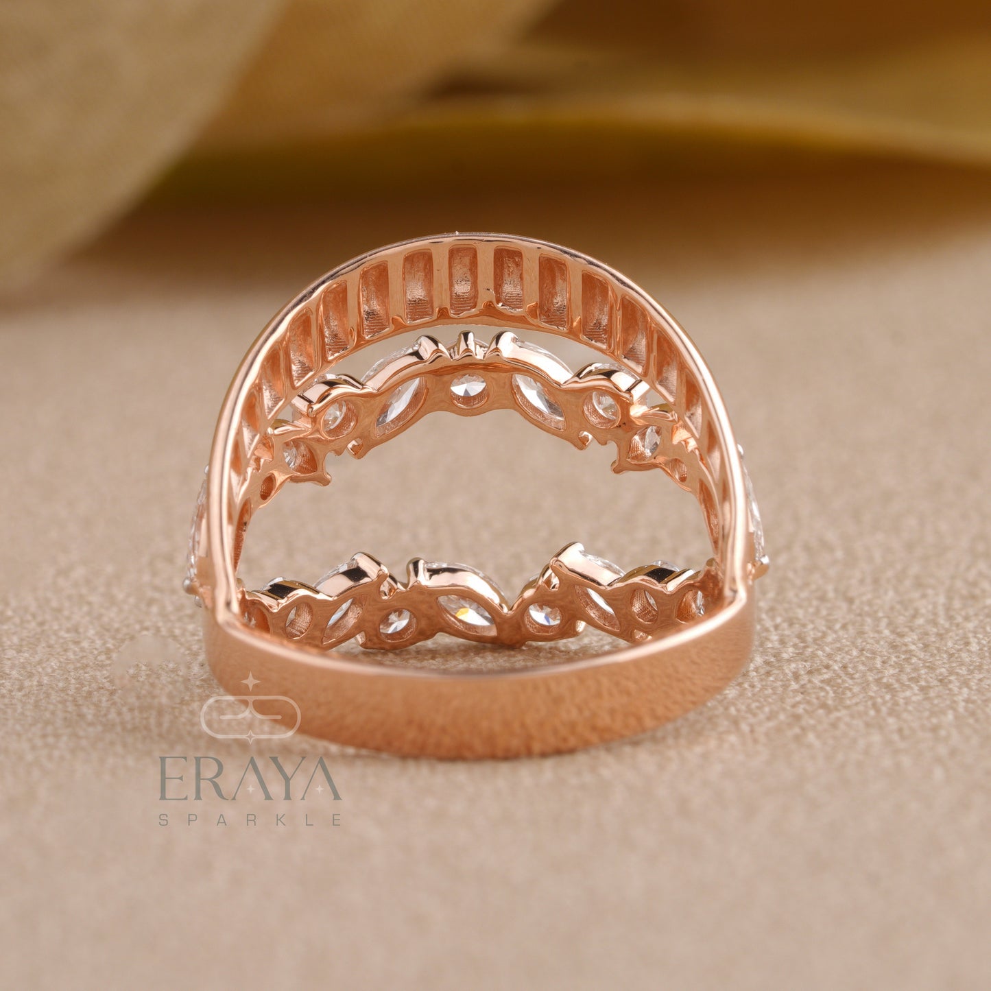 Close-up of marquise cut diamonds arranged in a leaf pattern on gold ring.