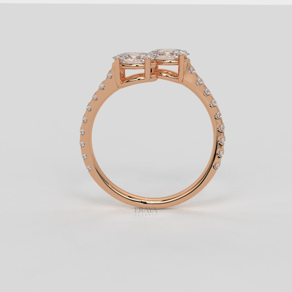 Rose gold ring with diamond accents on a light gray background
