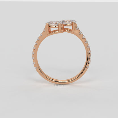 Rose gold ring with diamond accents on a light gray background