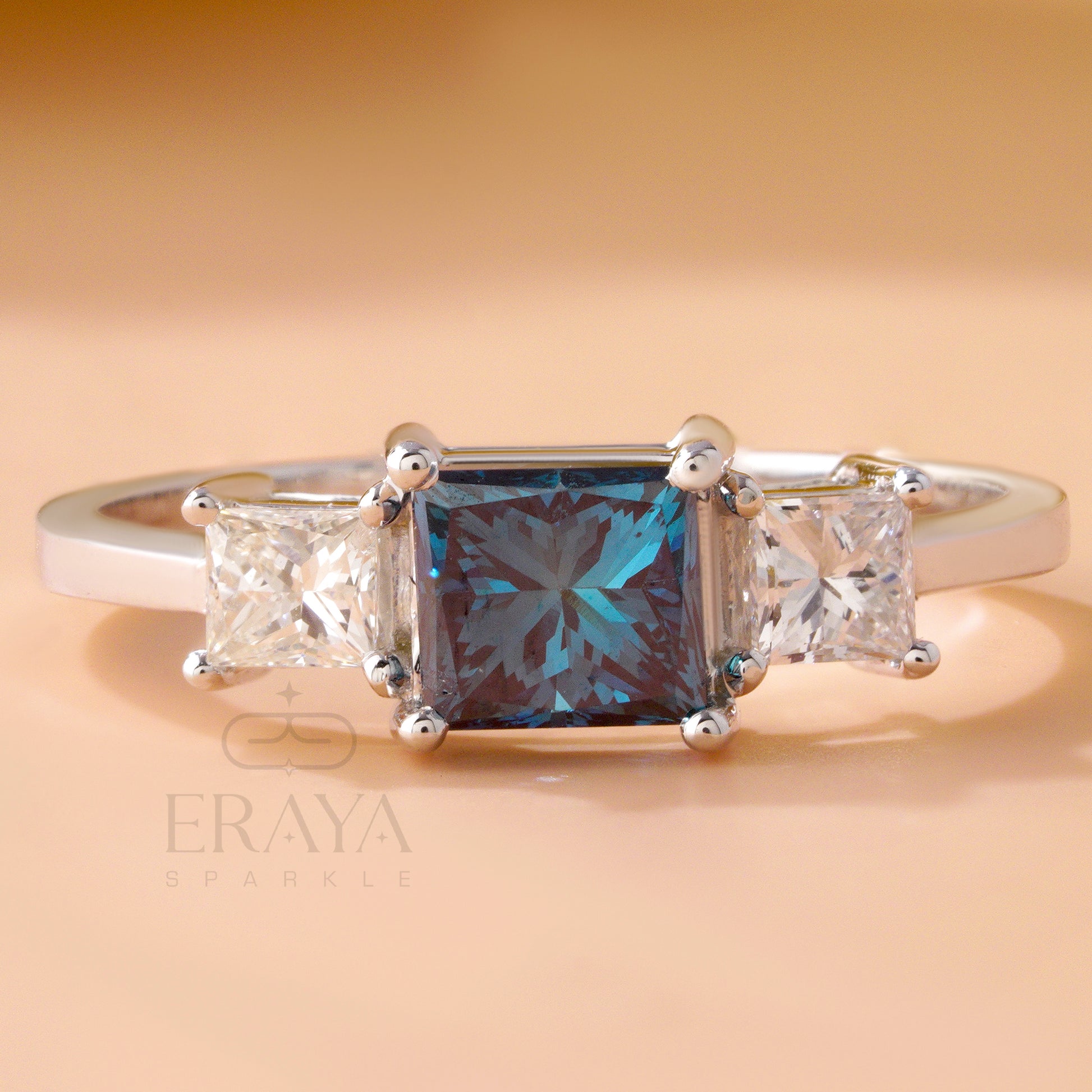 Princess cut blue diamond ring with side white diamonds