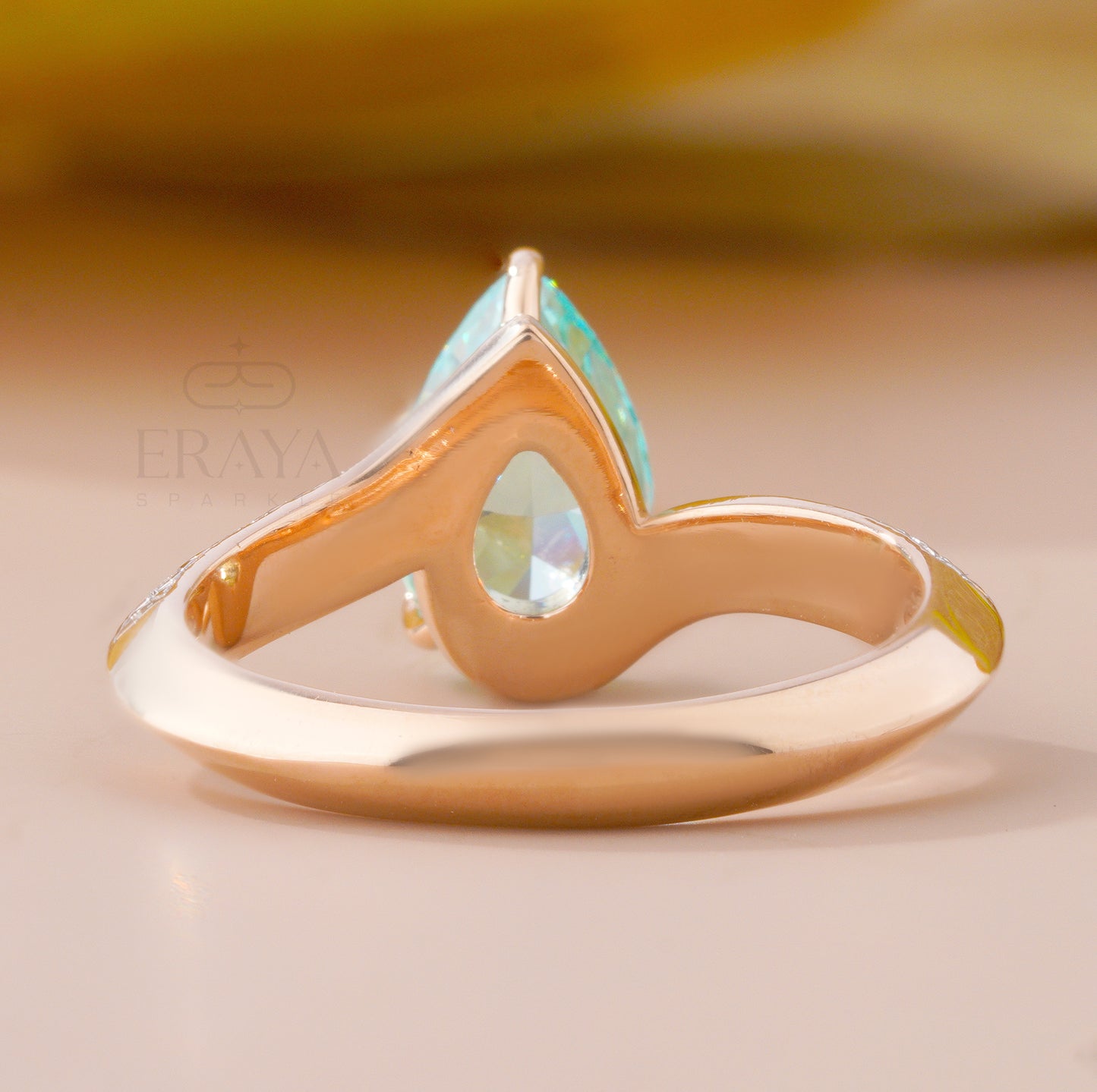 Gold ring with a turquoise stone on a beige background