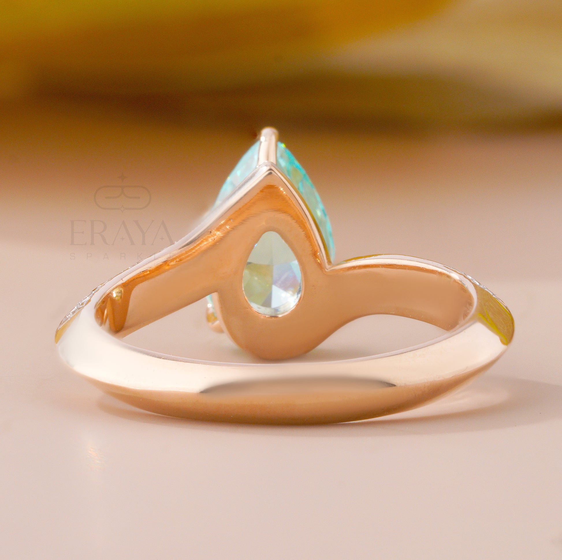 Gold ring with a turquoise stone on a beige background