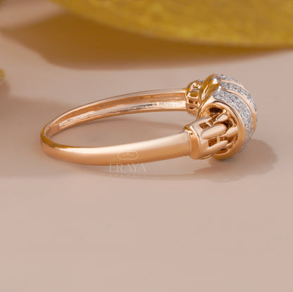 Gold ring with intricate design on a beige background