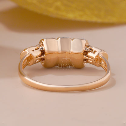 Gold ring with a textured band on a beige background