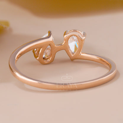 Rose gold ring with clear gemstones on a beige background