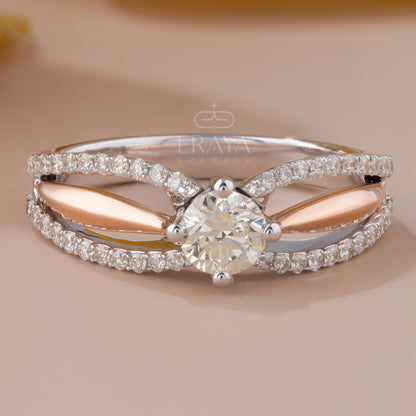 Diamond ring with pear-shaped center stone on a beige background, featuring the brand 'Eravia'.