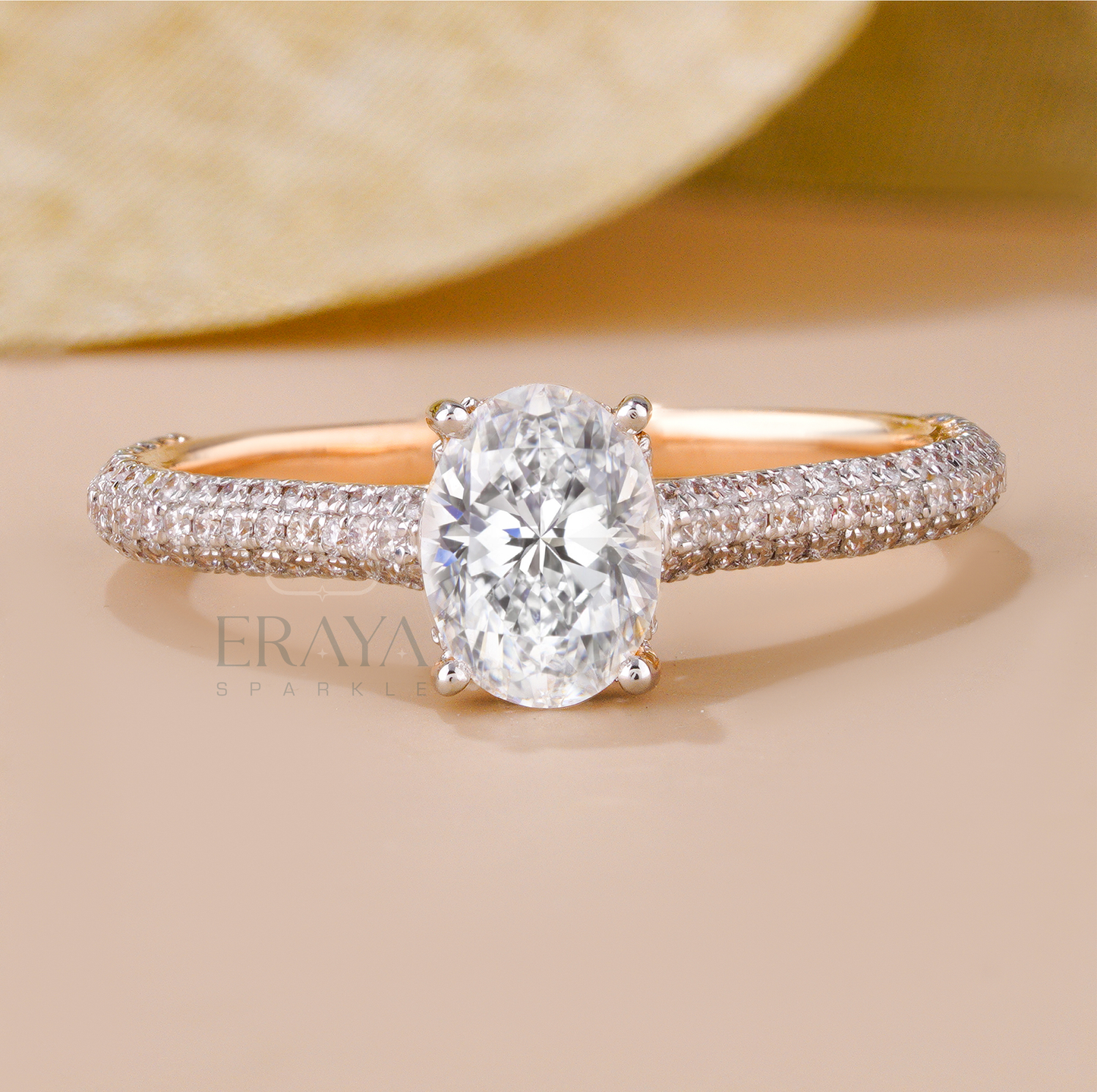 Rose gold oval solitaire ring with triple row diamond accents