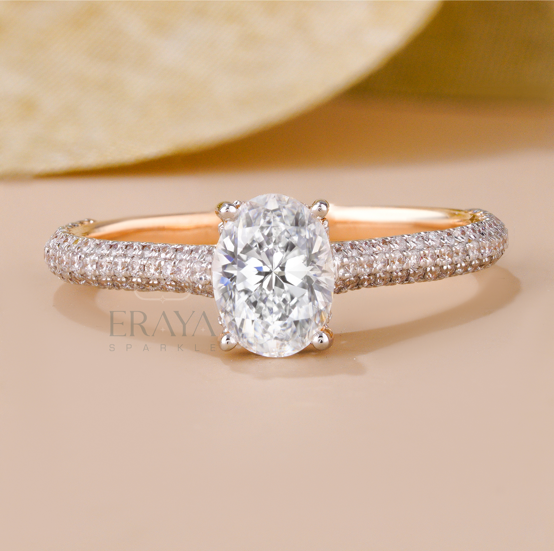 Rose gold oval solitaire ring with triple row diamond accents