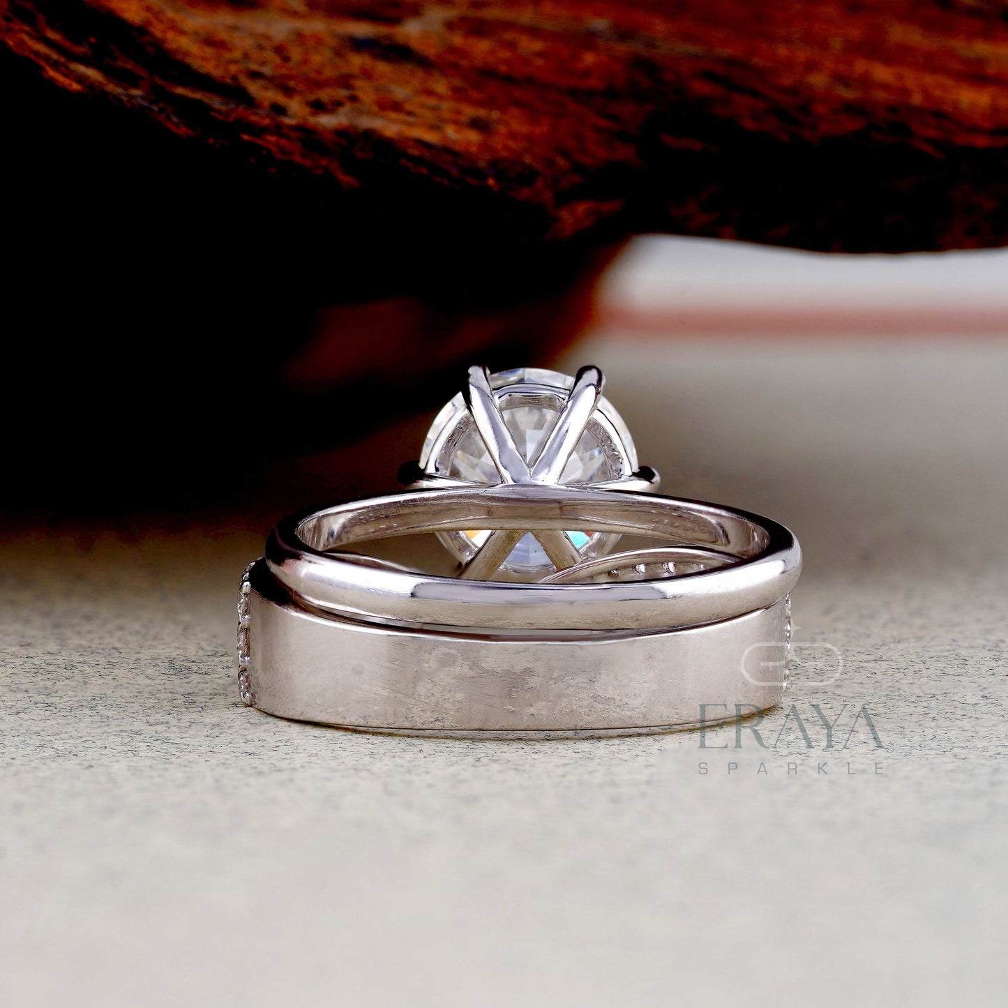 Silver ring with a diamond on a textured surface, featuring the brand 'Eraya Sparkle'.