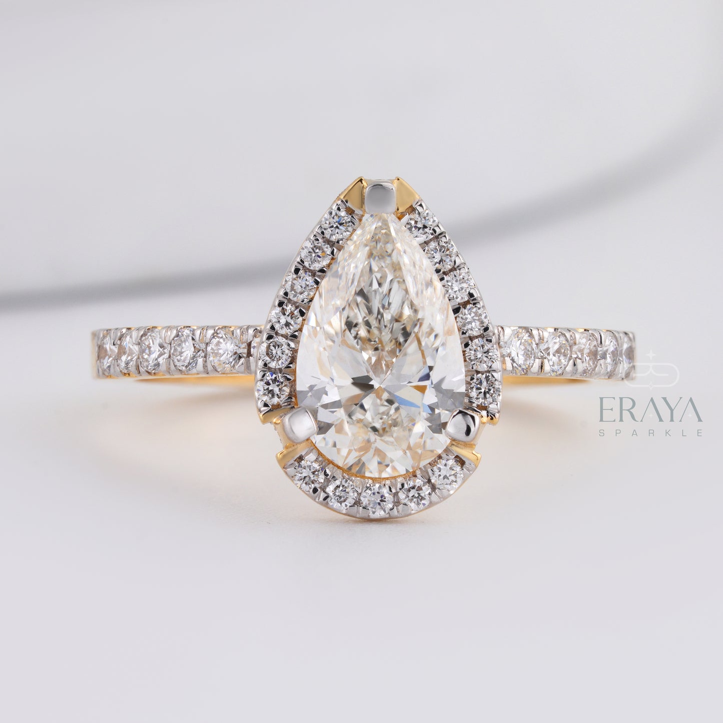 side view pear cut engagement ring showing prong setting and band detail