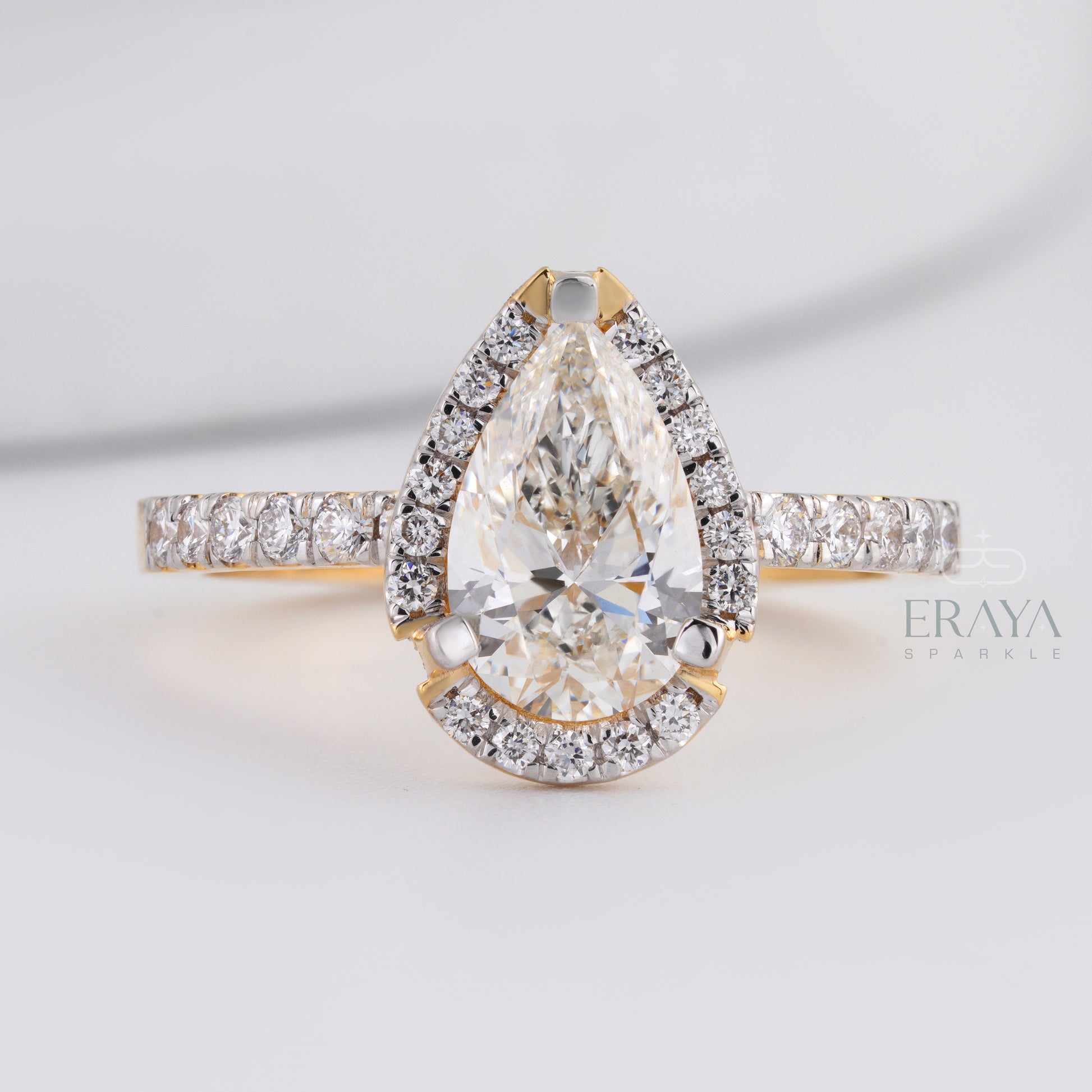 side view pear cut engagement ring showing prong setting and band detail