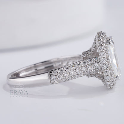 close up halo setting and pavé diamonds around emerald center stone