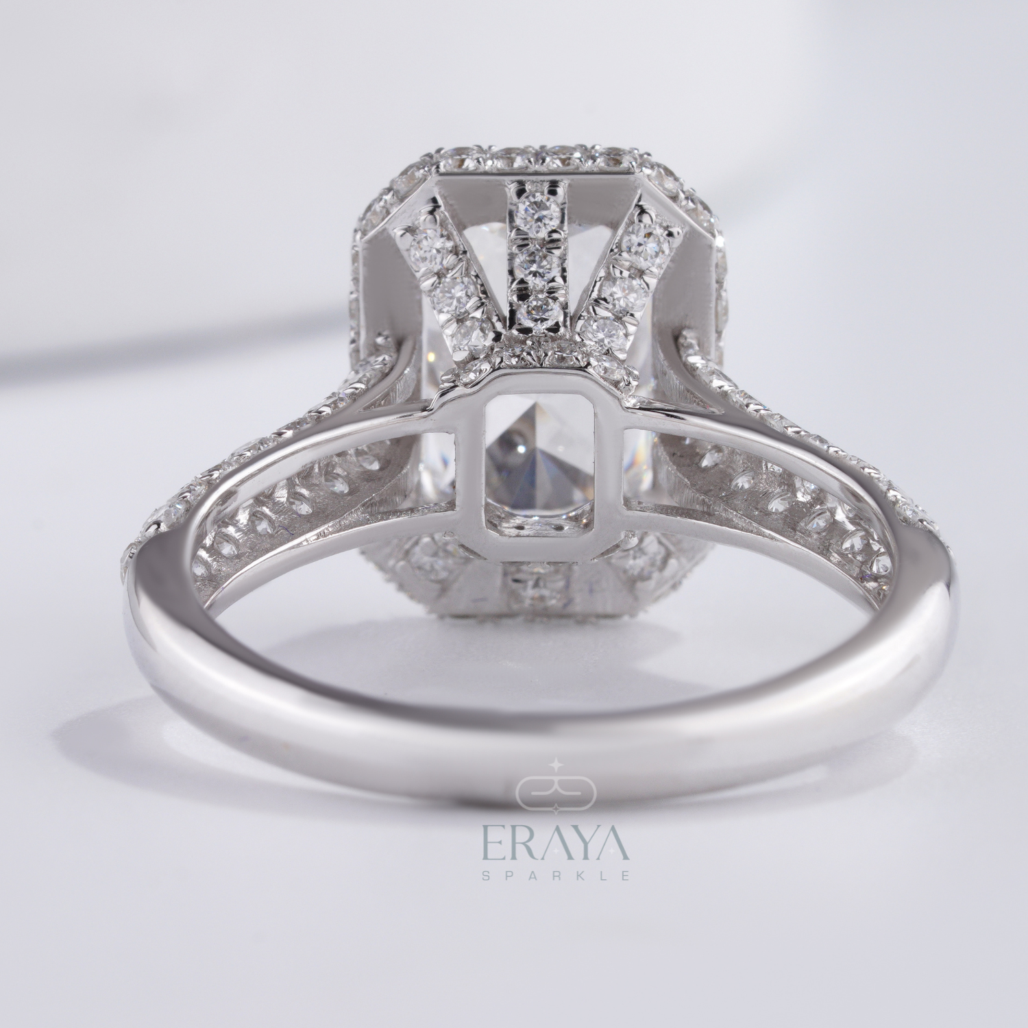 luxury bridal ring package with emerald cut halo engagement ring