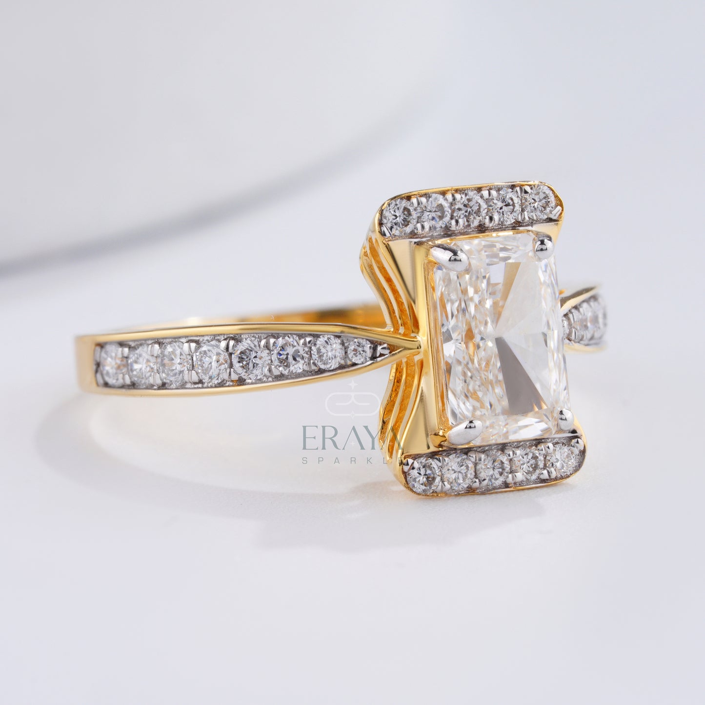 Gold ring with a large central gemstone and smaller diamonds on a light background