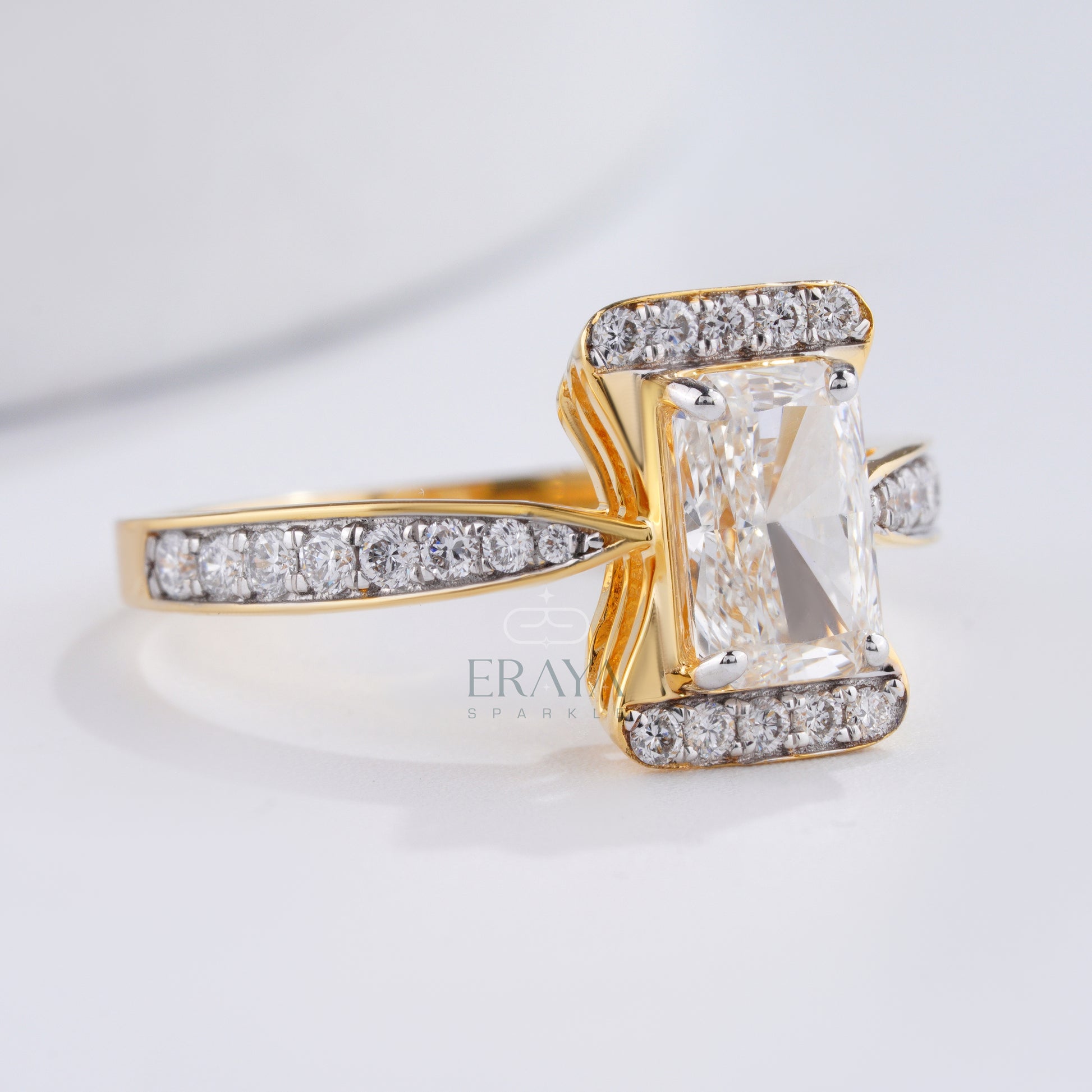 Gold ring with a large central gemstone and smaller diamonds on a light background