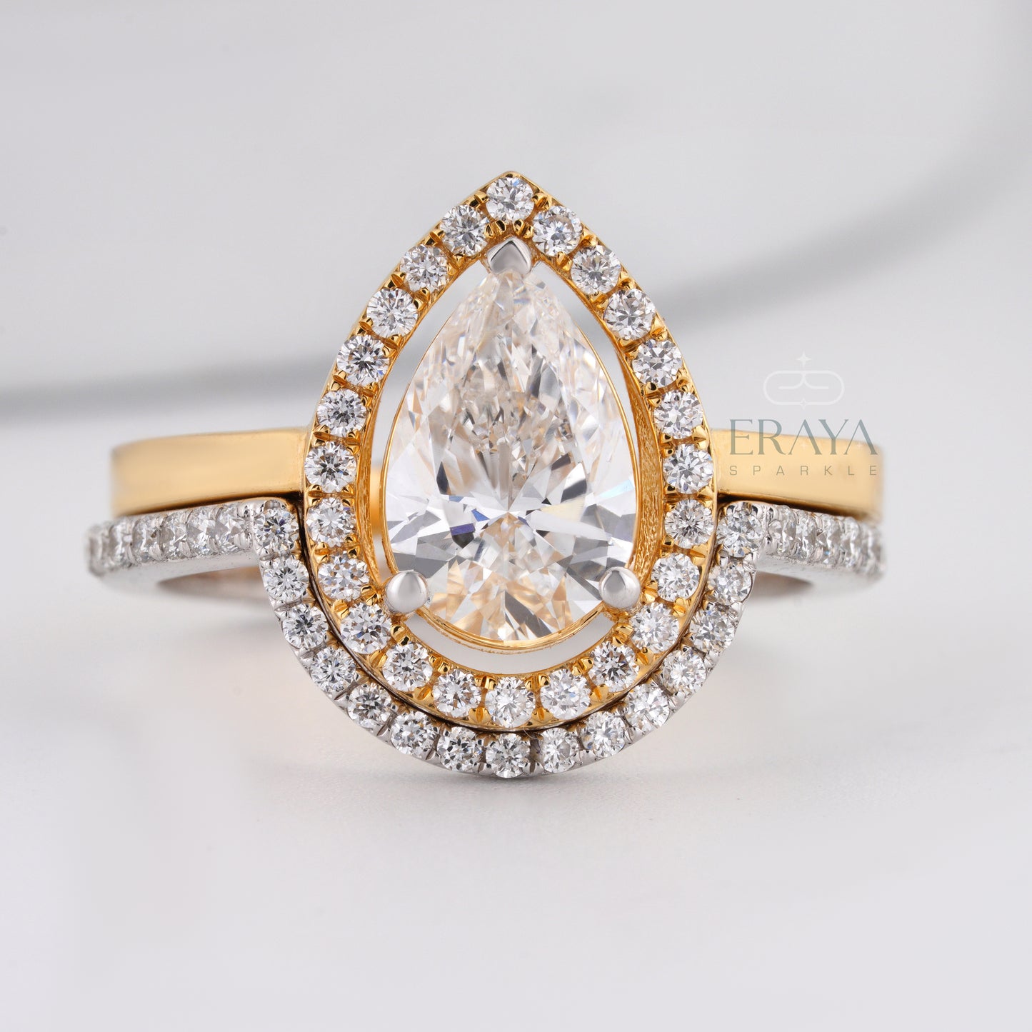 Pear cut lab-grown diamond halo engagement ring in two-tone gold