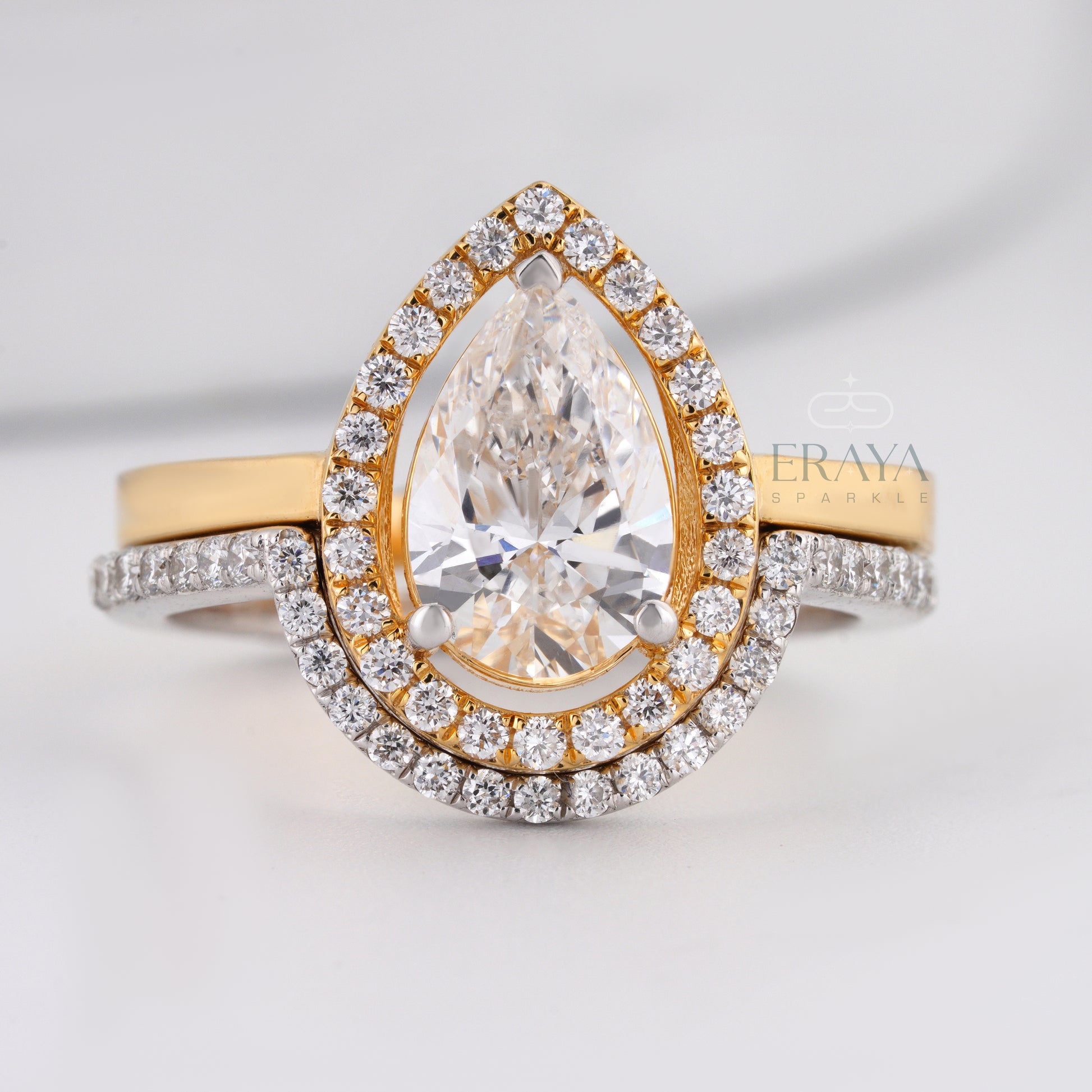 Pear cut lab-grown diamond halo engagement ring in two-tone gold