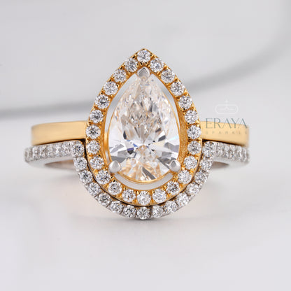 Pear cut lab-grown diamond halo engagement ring in two-tone gold