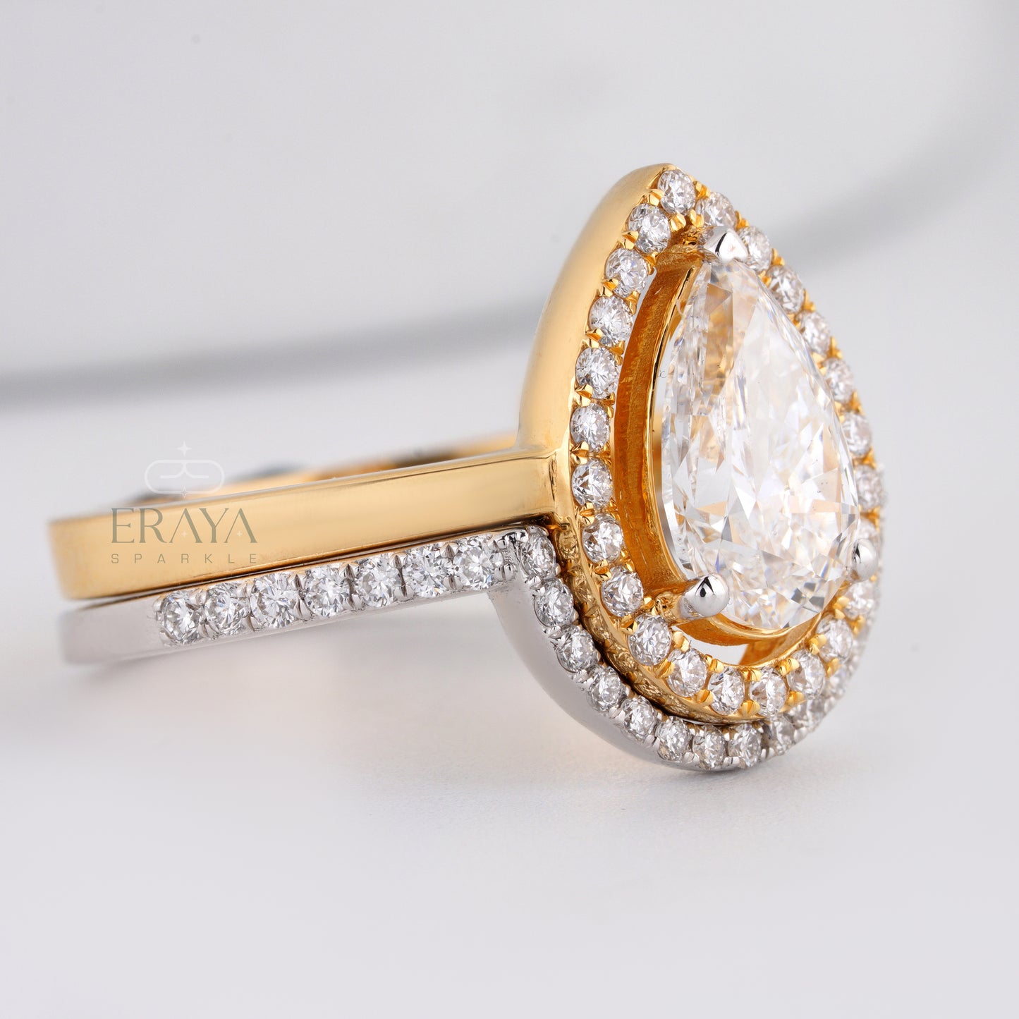 Stackable pear-shaped diamond ring set with halo and matching band