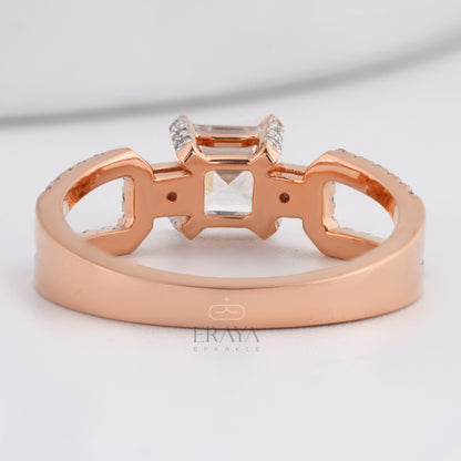 Rose gold ring with diamond accents on a light gray background