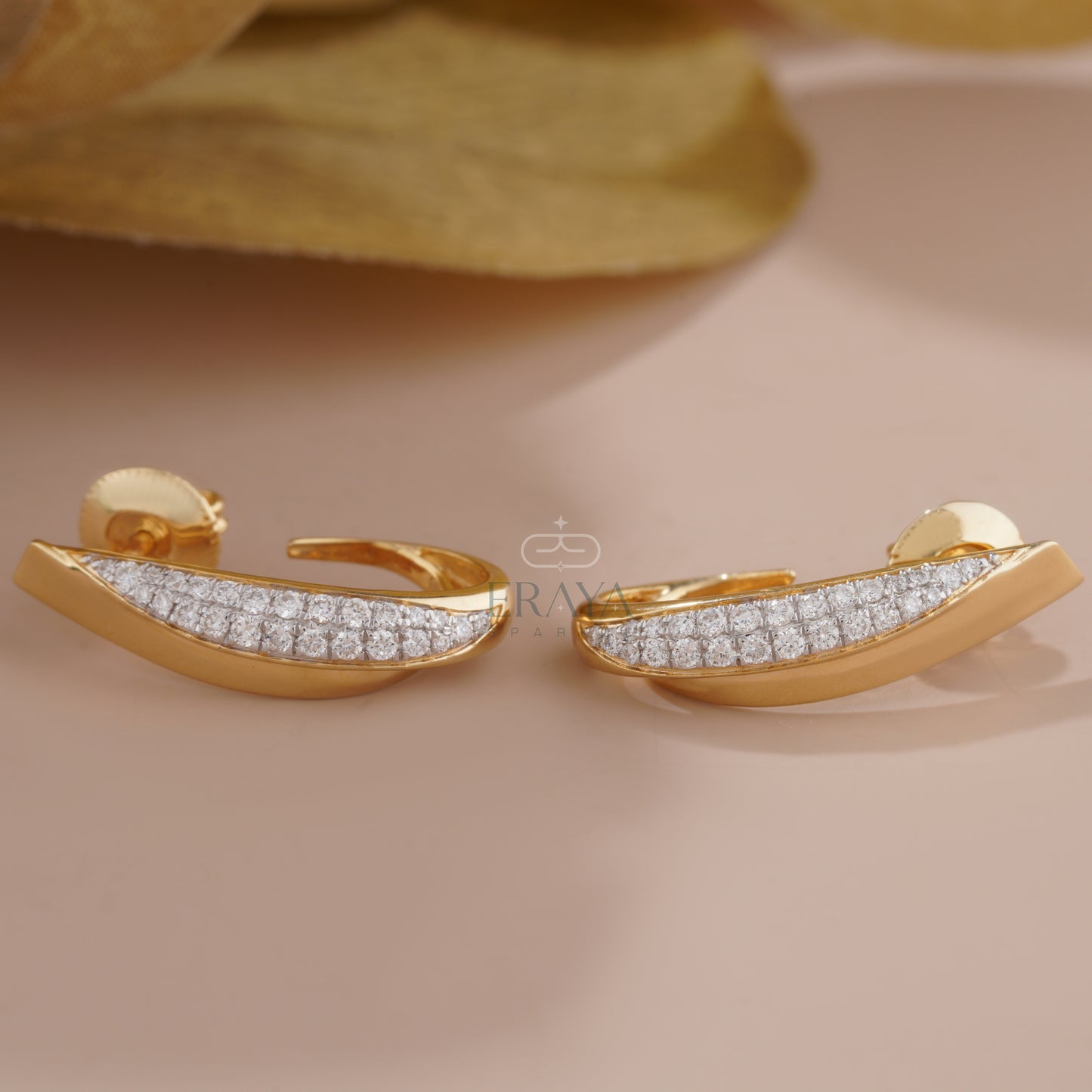 curved-gold-diamond-earrings-detail-close-up