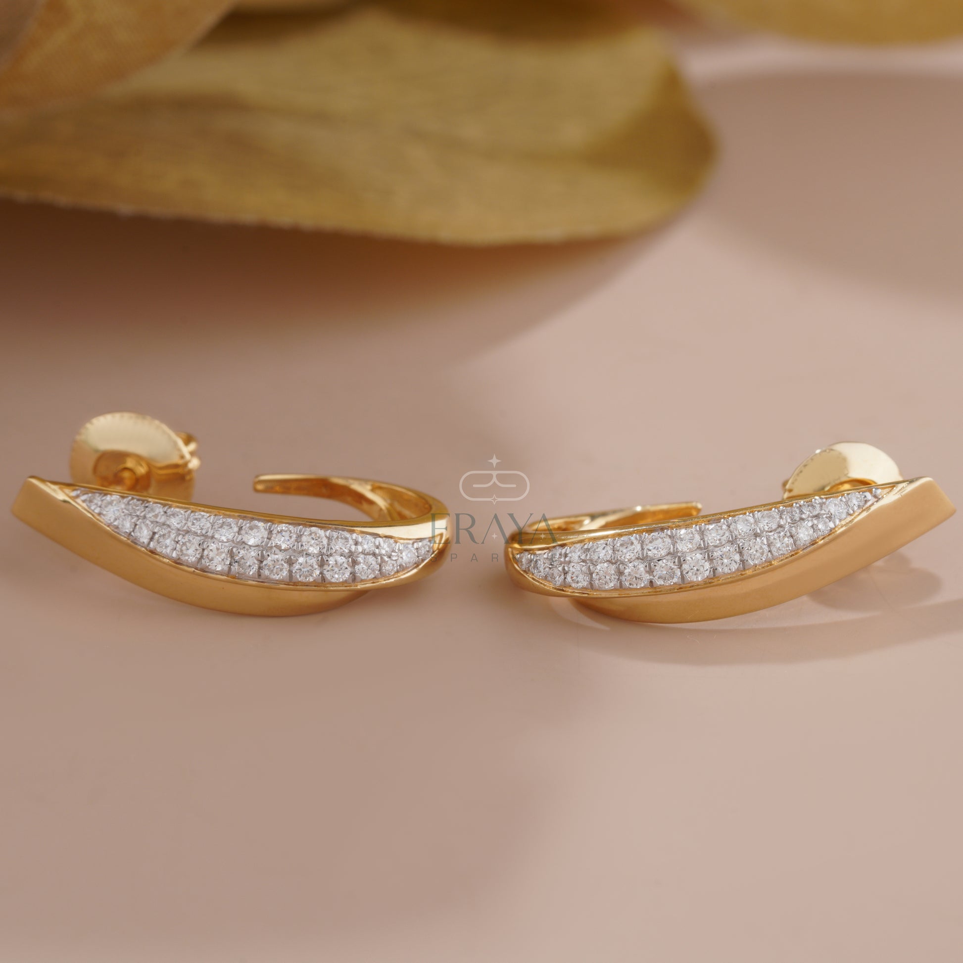 curved-gold-diamond-earrings-detail-close-up