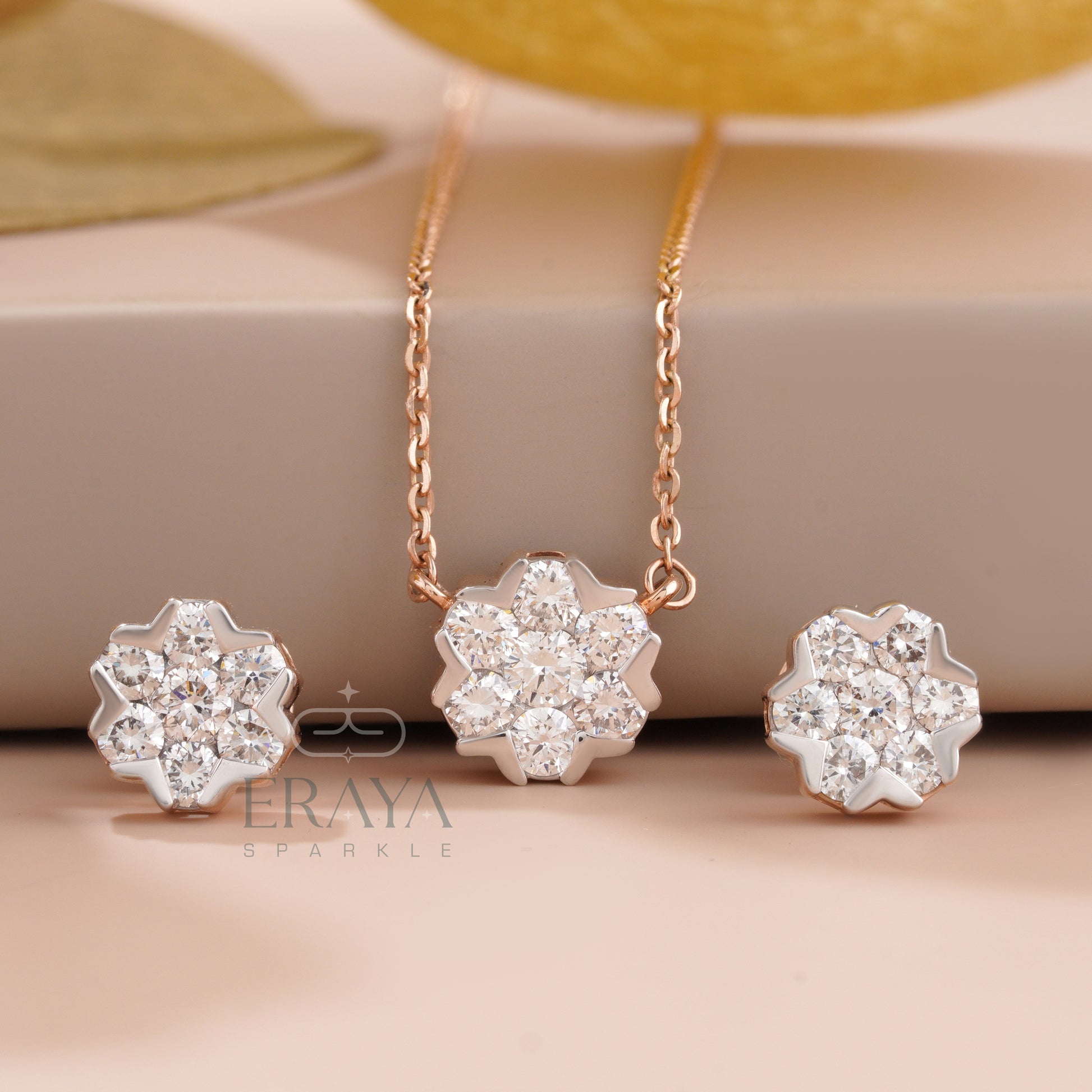 Snowflake cluster necklace and matching snowflake earrings in solid gold — front view