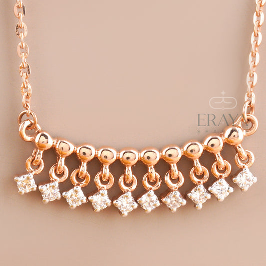 Close-up of dangling diamond charms on polished rose gold bar – lab grown diamonds IGI certified