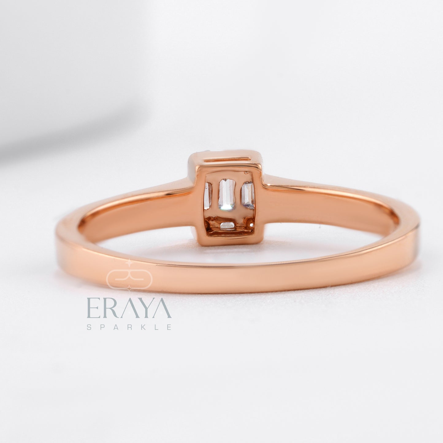 Rose gold ring with a diamond on a light gray background, featuring the brand 'Eraya'.