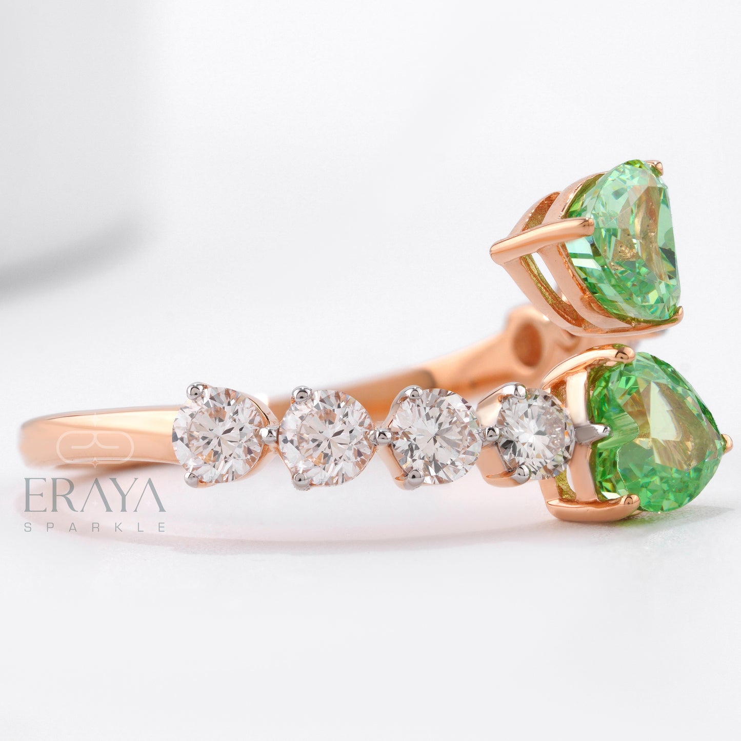 Rose gold ring with green gemstone and diamond accents on a white background, featuring the brand 'Eraya'.