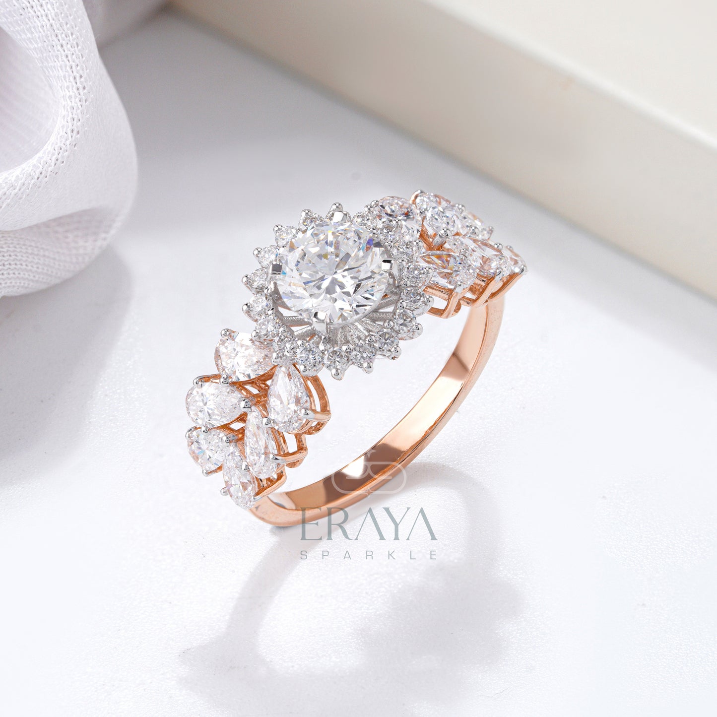 Solitaire diamond halo ring in rose gold with pear accents