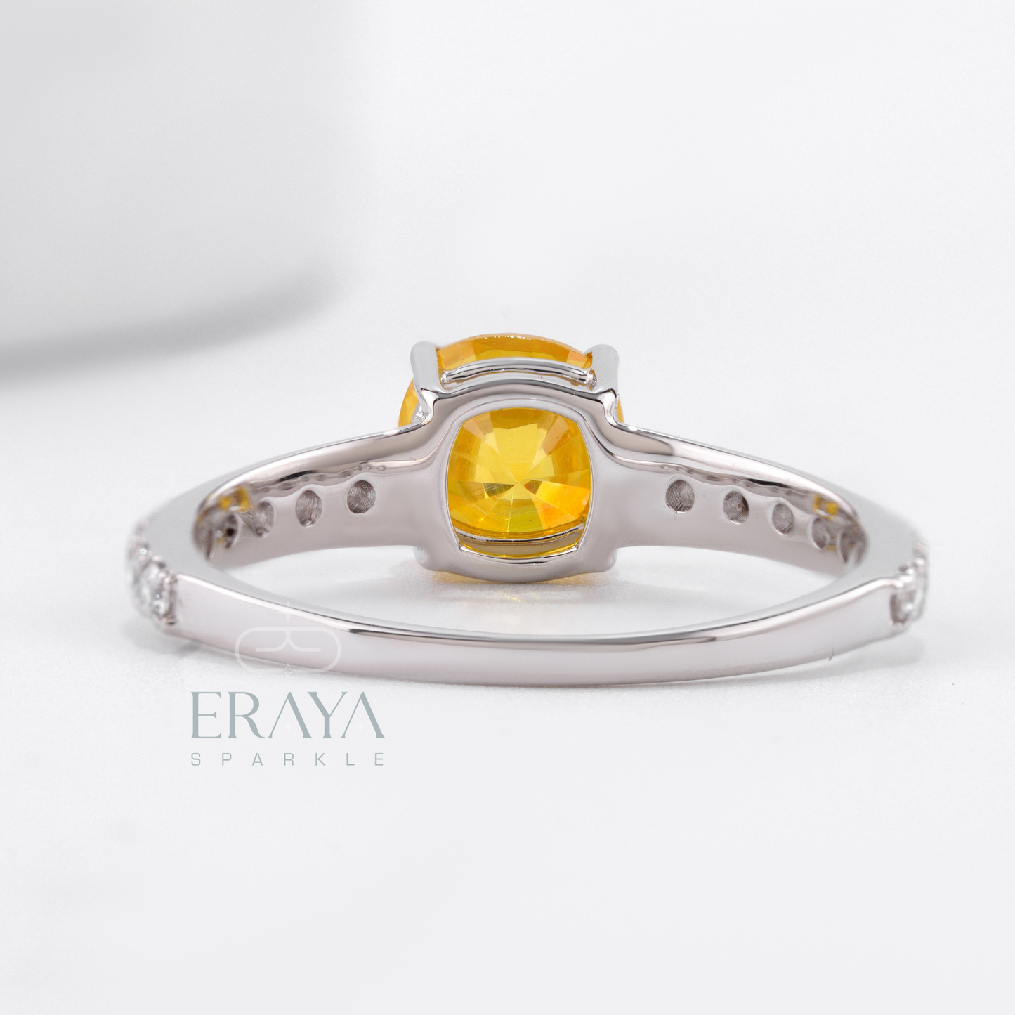Polished white gold ring featuring yellow sapphire and diamonds