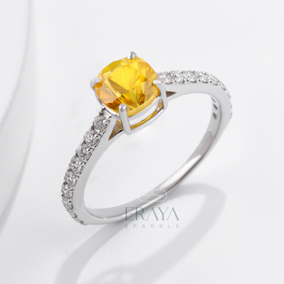 Cushion cut yellow sapphire ring in white gold with diamond pavé band