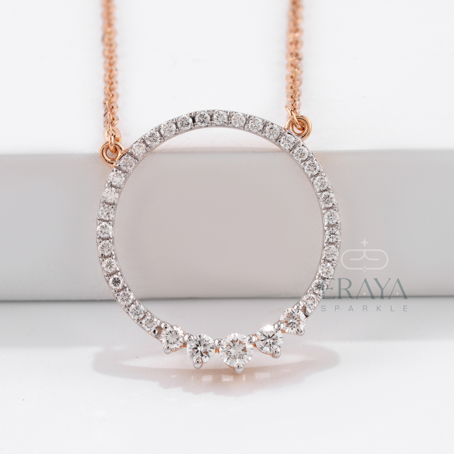 Close-up of open circle with three accent stones at base - diamond solitaire pendant option