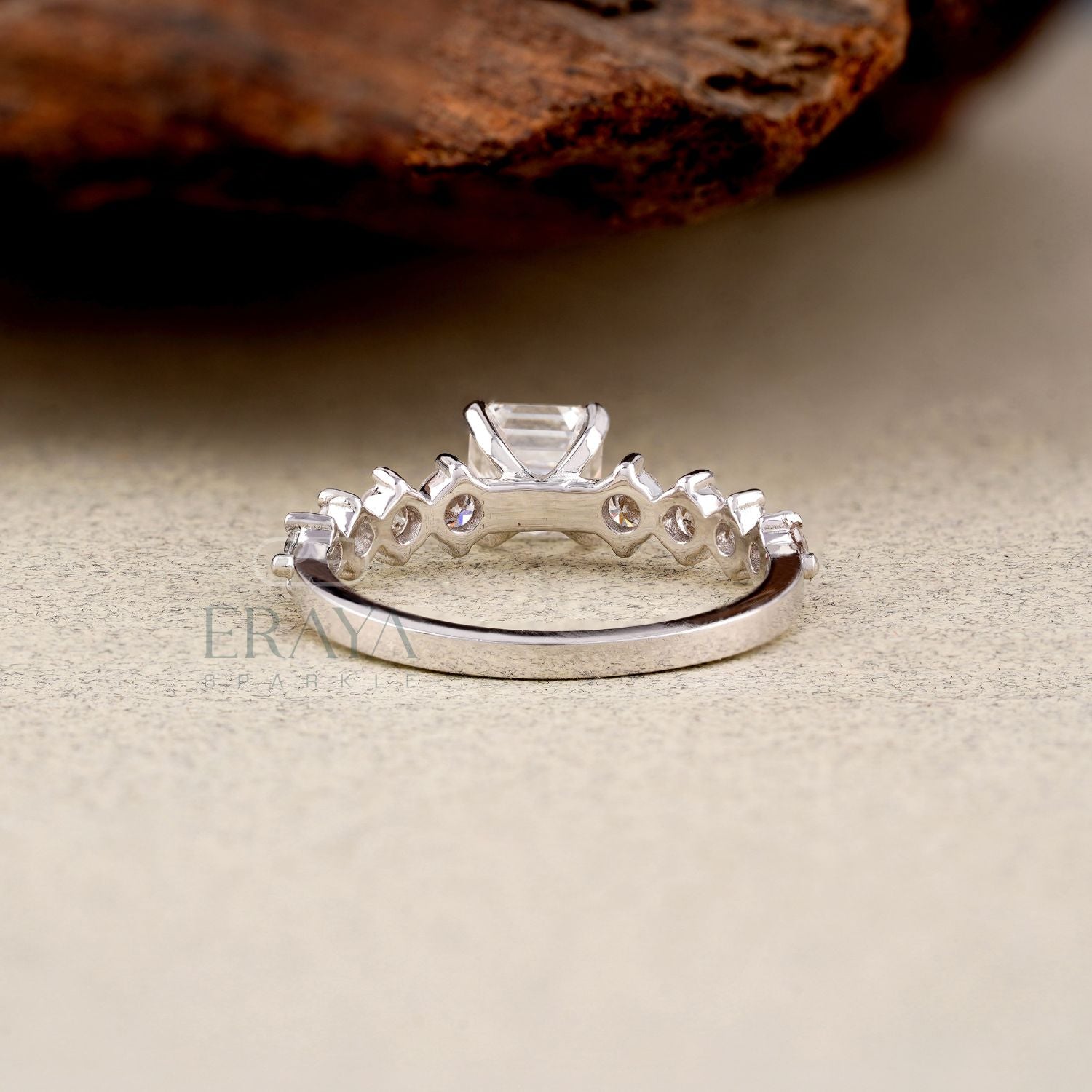 Silver ring with gemstones on a textured surface