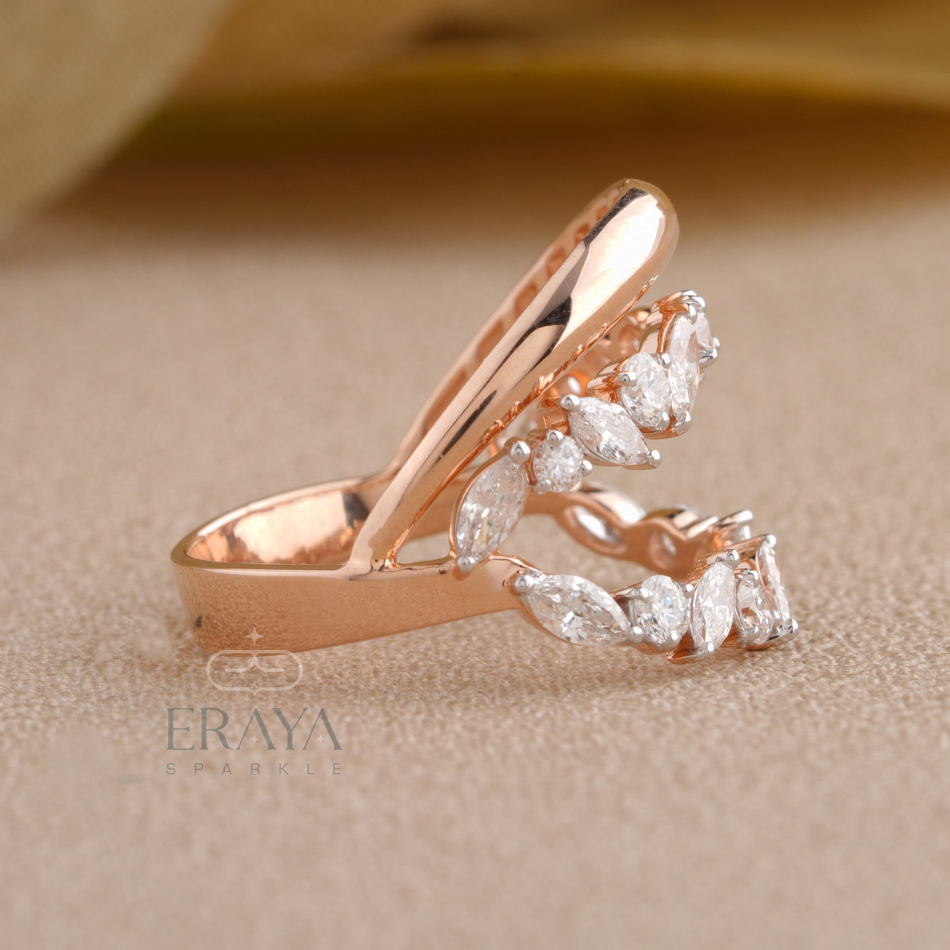 Side profile of leaf-shaped marquise diamond ring highlighting curved gold design.