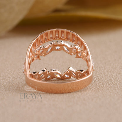 Close-up of marquise cut diamonds arranged in a leaf pattern on gold ring.