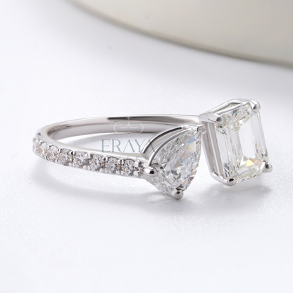 Silver ring with a large diamond and smaller diamonds on the band, on a light background.