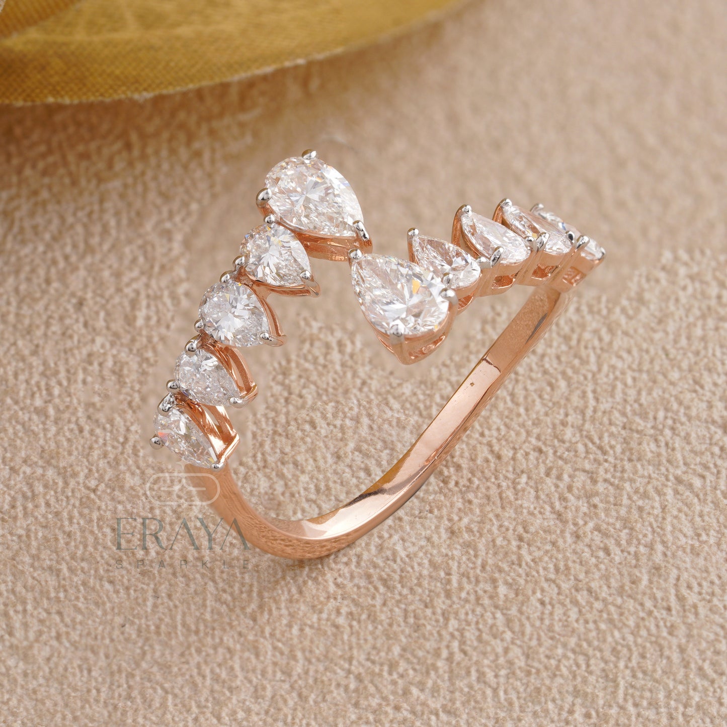 Top view of ERAYA pear-cut lab-grown diamond open band ring showing V-curve layout and overall silhouette