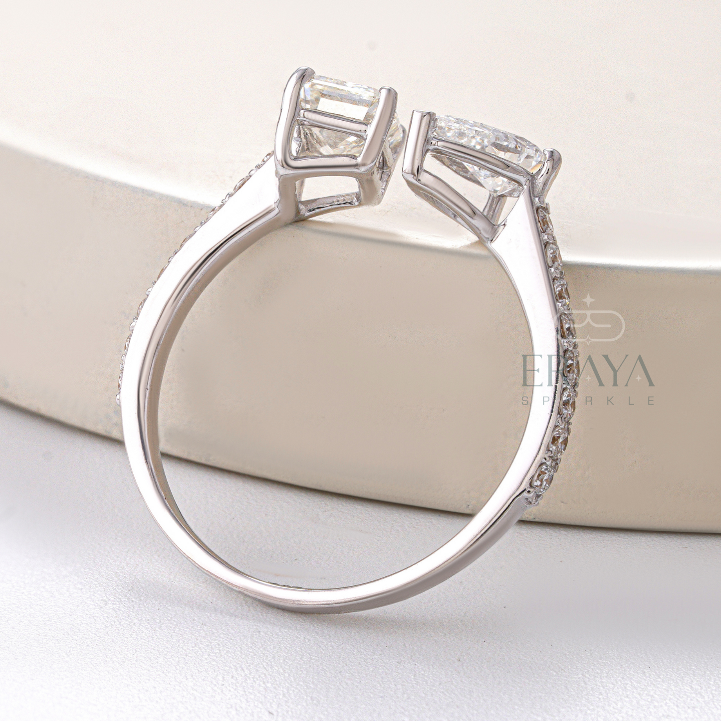 Silver ring with diamond accents on a white surface