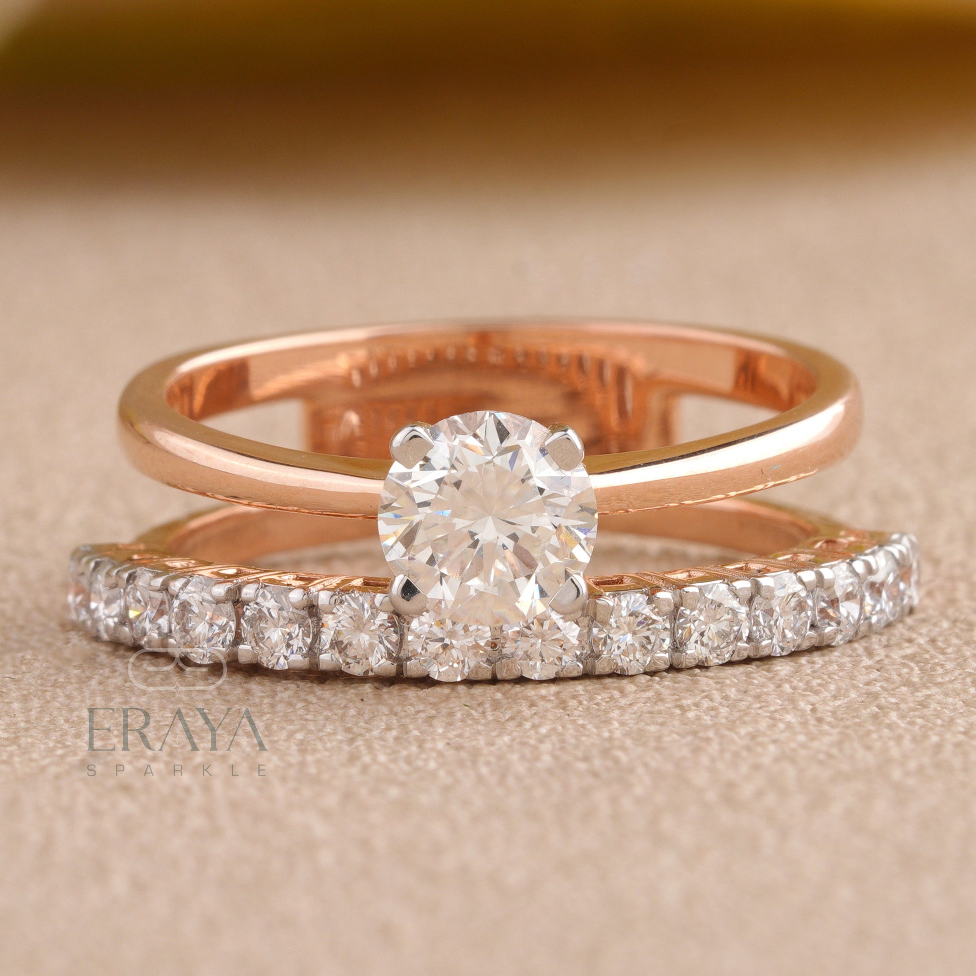 Front view of ERAYA gold solitaire ring highlighting round brilliant center diamond and pavé shoulders