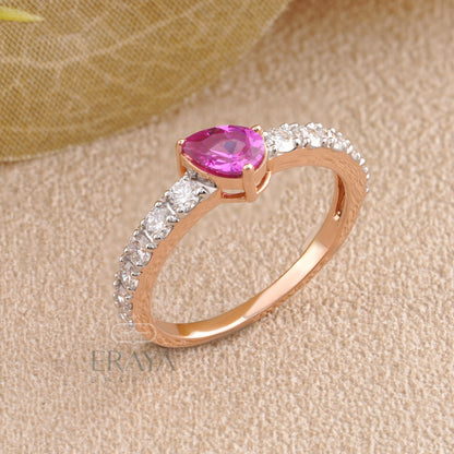 Top view of pear pink color stone ring showing pear center and diamond accents