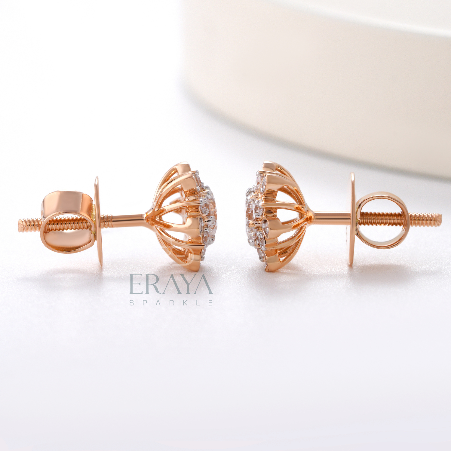 Side profile of rose gold sunburst diamond earrings with halo detailing