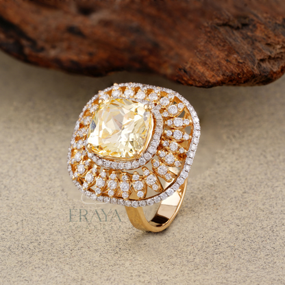 Top view of yellow cushion cocktail ring showing 10mm center stone and diamond halo