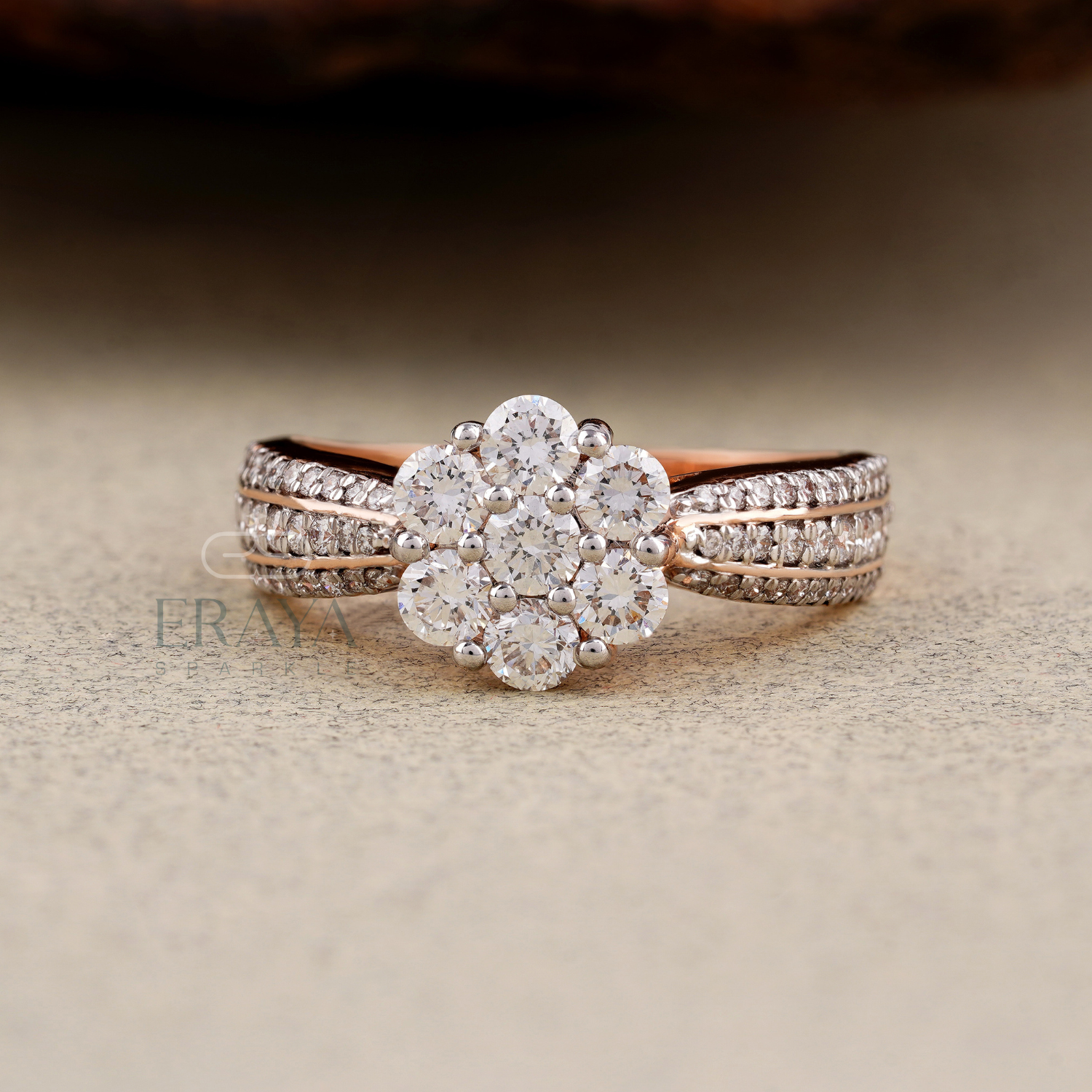 Rose gold and silver ring with diamond accents on a textured surface