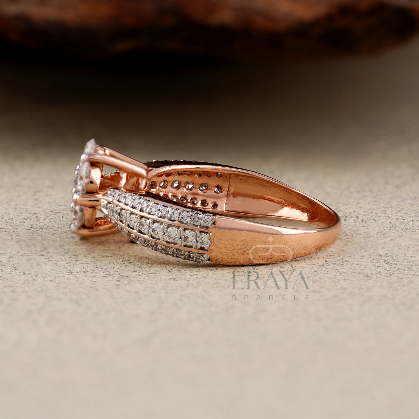 Rose gold ring with diamond accents on a beige background, featuring the brand 'Eraya Sparkle'.