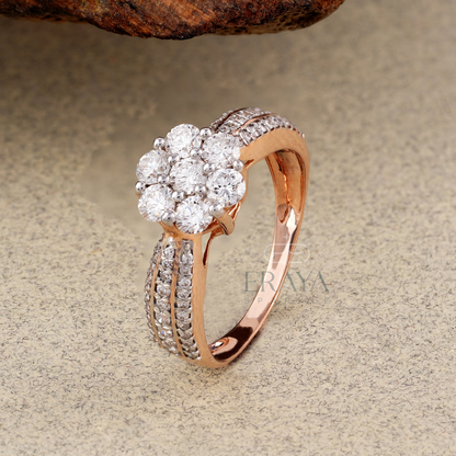 Rose gold ring with diamond cluster on a textured surface