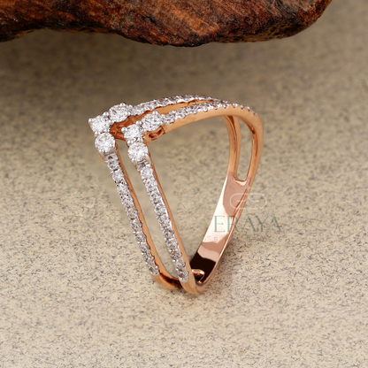 Rose gold ring with diamonds on a textured surface