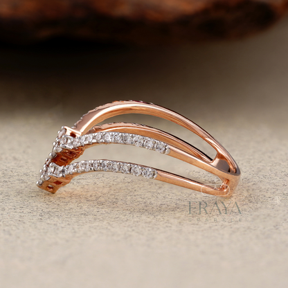 Rose gold ring with diamonds on a textured surface